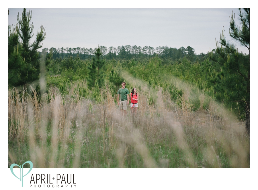 Couple laughing in a field in Mississippi