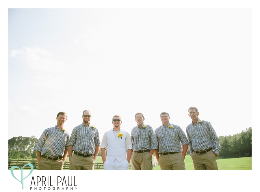 Groomsmen pose at small backyard wedding in Mississippi