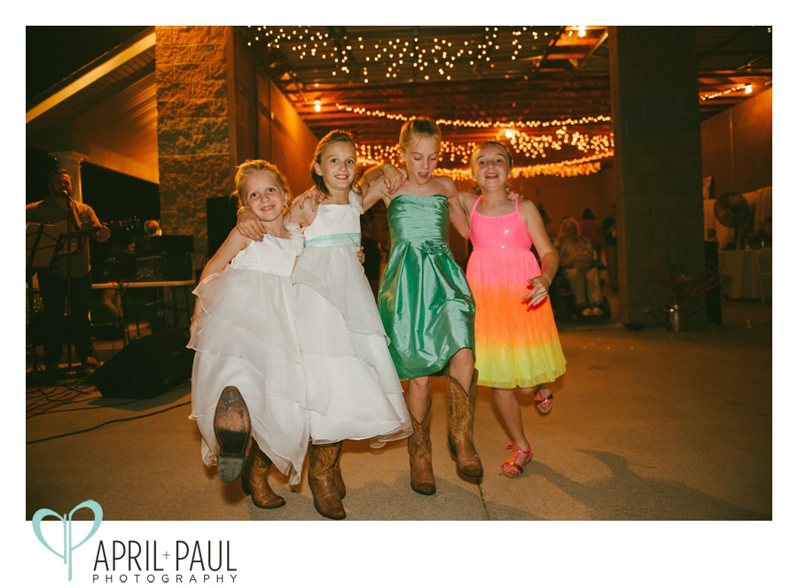 little girls dancing with cowboy boots at backyard wedding in Mississippi