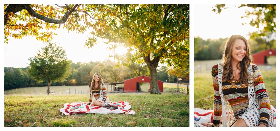 Country themed senior session with a red barn and vintage quilt